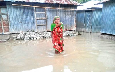 洪水に沈んだ村の彼女の家から出てくる女性